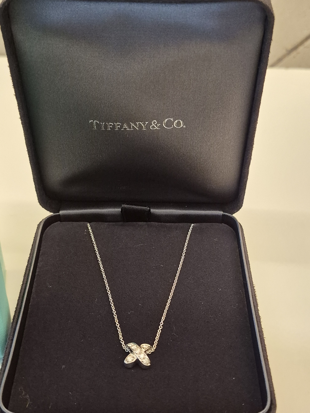 Tiffany & Co. 18k White Gold Diamond X Pendant Necklace With Suede Tiffany Box.